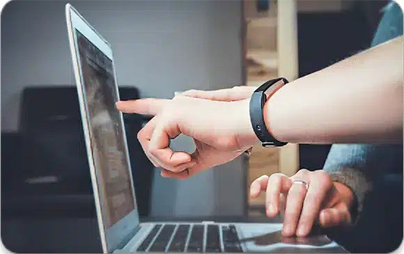 Person using a laptop for remote tech diagnostics